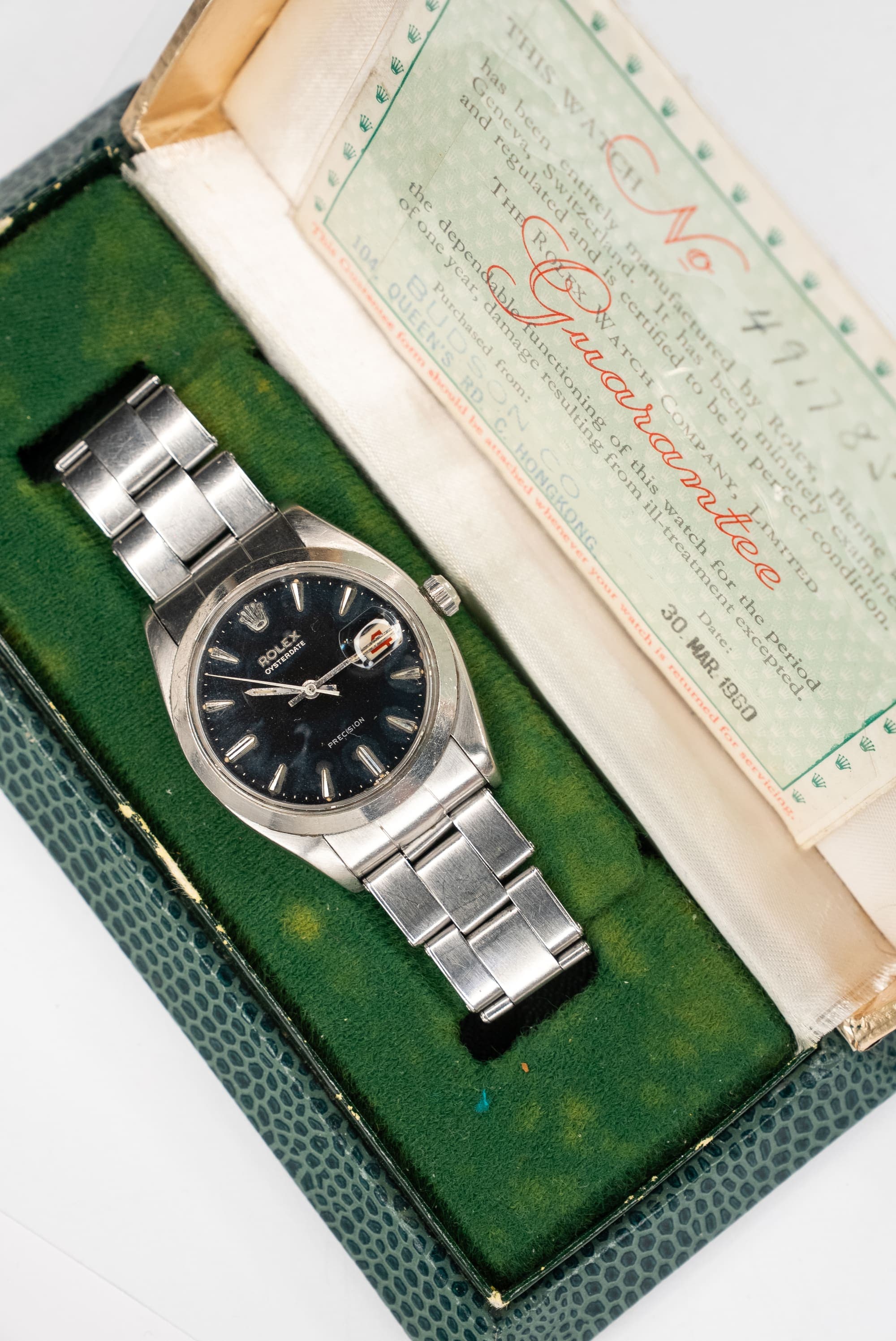 A vintage watch with its original box and guarantee papers